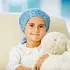 Child with hair loss wearing a blue hat